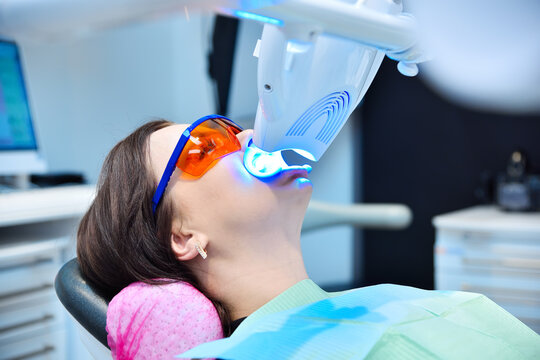 Teeth whitening for patient in protective glasses.