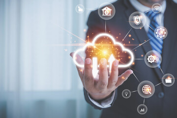 The Businessman holding the cloud computing innovation technology to the future with business icons. Internet storage network upload and download concept. Large database big data through technology.