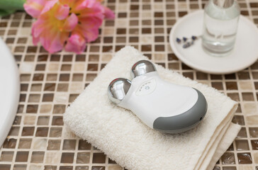 microcurrent facial toning device on countertop. Concept of wellness, beauty and skincare. side view