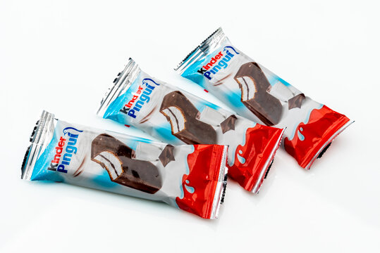 Alba, Italy - March 28, 2022: kinder Pingui Ferrero sponge cake snack filled with milk cream covered with chocolate, produced by Ferrero important confectionery factory in the world