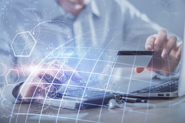 Double exposure of man hands holding a credit card and world map drawing. International Internet E-commerce and technology concept.