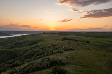 Magnificent aerial view of the Dniester River with picturesque banks during sunset. Bakota National Natural Park, Podolskie Tovtry, Ukraine. Beautiful view from a flying drone.