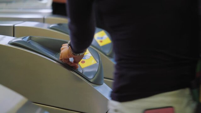 People drop coins into wicket control panel in Subway, pass through Turnstile, paying for enter, Rush hour Metro 
