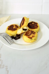 Syrniki, cottage cheese fritters with chocolate, minimalist style, vertical, copy space