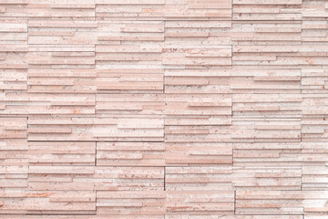 the background masonry of the wall is a narrow long brick tile modern, brown peach pastel color, light pink