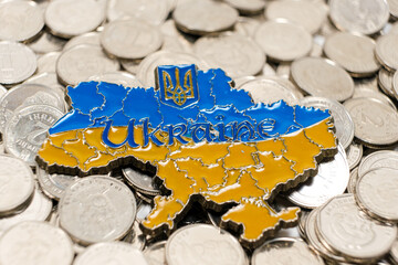Map of Ukraine on Ukrainian hryvnia coins. Money crisis in the country, international aid and investment