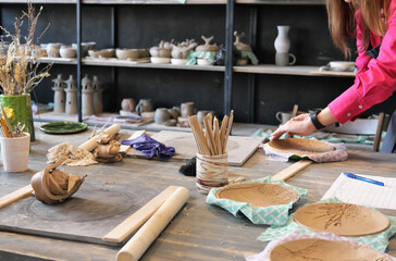 Clay plates and pottery made by a young woman.