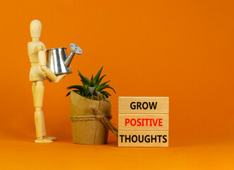 Grow positive thoughts symbol. Concept words Grow positive thoughts on blocks. Businessman model....