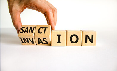 Sanction against invasion symbol. Businessman turns cubes and changes the concept word Invasion to Sanction. Beautiful white background. Business sanction against invasion concept. Copy space.