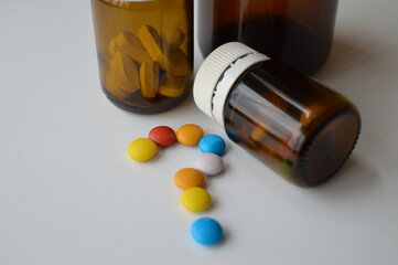 medical pills and tablets spilling out of a drug bottle