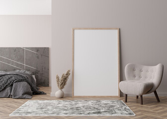 Empty vertical picture frame standing on parquet floor in modern bedroom. Mock up interior in contemporary style. Free space for picture or poster. Bed, armchair, pampas grass. 3D rendering.