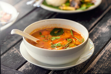 Tom Yam traditional soup with seafood, mushrooms, coconut milk and hot spices