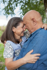 Fototapeta premium Portrait of beautiful senior couple posing in park
