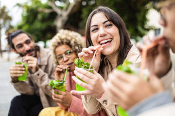 Happy smiling diverse young friends drinking mojito at the street. Millennial people having fun together toasting alcoholic beverages in summer vacation