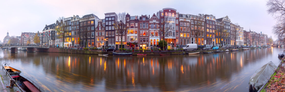Panorama of the city waterfront of Amsterdam at sunset. © pillerss