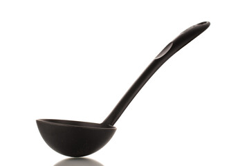 One black silicone kitchen spoon, close-up, isolated on a white background.