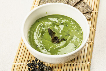 Kelp puree isolated on white background. Healthy superfood from oceanic seaweed