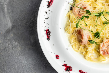 Pasta with grilled shrimps, bechamel sauce, cheese and microgreen, italian cuisine, banner, menu, recipe place for text, top view