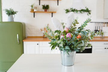 Easter bouquet and eggs on the table In white Scandinavian-style kitchen. Beautiful greeting card. The minimal concept