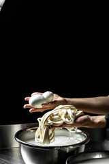 Cheesemaker, showing freshly made mozzarella. The homemade cheese maker produces caciocavallo. Pasta filata, Traditional Italian mozzarella