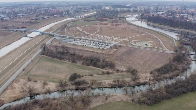Opole aerial cityscape. Bolko Island, Canal Ulgi and Odra River Oder. Early spring. Drone aerial view in 4k UHD real time. Tilt up reveal.
