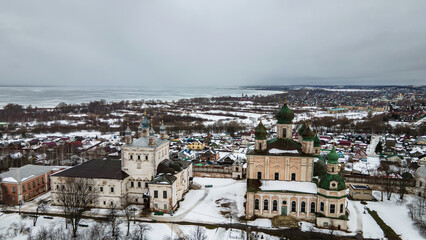 Beautiful old church with towers and domes. Winter day. Overcast weather. Ancient architecture.