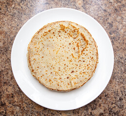 Fried pancakes on a plate on the table.