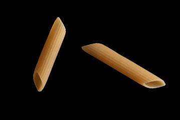 Dried pasta isolated on black background.