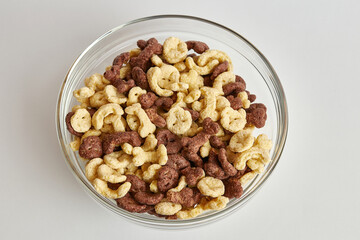 Granola in a transparent bowl on a white background. Healthy food. Baby food.
