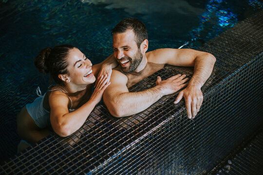 Young couple relaxing in a swimming pool