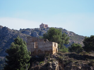 Fototapeta premium antigua ermita de sant jordi en la sierra de la carbonera, pirineos de lérida, en primer plano se encuentran los restos del castillo del pueblo de camarasa, españa, europa