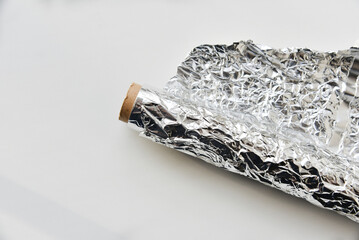 Aluminum foil roll on white background