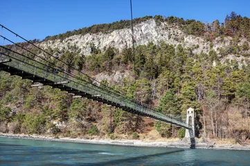Fotobehang The suspension bridge Stamser Steg was opened on 25 July 1935 and spans the river Inn north of the town of Stams in Tirol. The single-span suspension bridge is a listed building. © BIB-Bilder