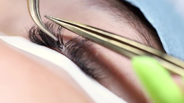 eyelash extension procedure, the master glues a bunch of cilia to the root of the hair