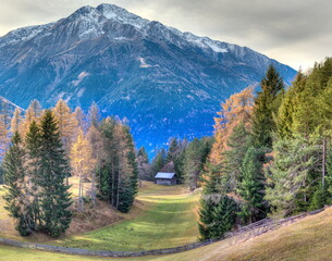 Lonely meadow valleys with old wooden huts in front of the impressive backdrop of the snow-covered mountains of the Karwendel mountains, this beautiful landscape can be found in the beautiful Tyrol.