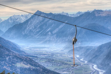 High above the Inn Valley in Tyrol, the ski lift stand still in December. Global warming is also...