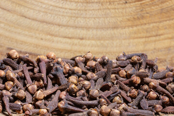 clove grains on wooden background