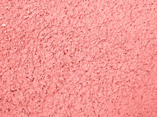 Textured pink peach colored wall cover of concrete. Facade of the building. Abstract grunge stucco wall texture. Abstract background.