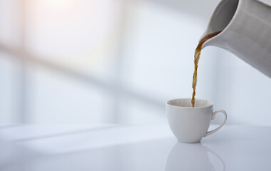 Coffee cup on table with window light and shadow drop on white wall background