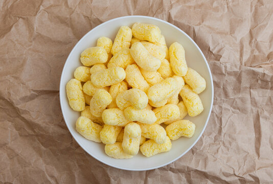 a full plate of corn sticks in icing sugar