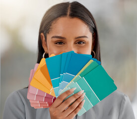 Every colour for your every need. Shot of a young woman holding different colour swatches while renovating her house.