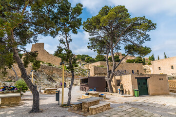 A view across a courtyard on the ramparts of the castle of Saint Ferran above Alicante on a spring day