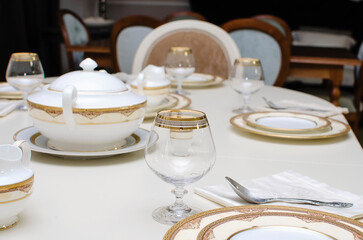 Beautiful empty dishes are on the table. The table is set for dinner.