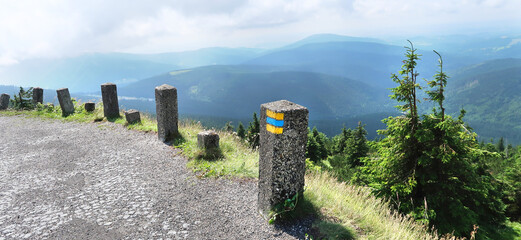 Colorful sign for bike tourism painted on the stone bollard on tourist path to Vrbatova Bouda in Krkonose (Giant Mountains), Czech Republic, Bohemian Region.