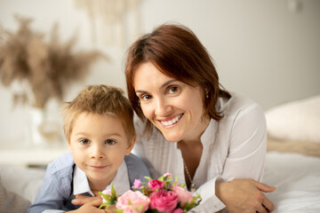Mother and child, blond fashion preschool boy, having a wonderful family happy moment together
