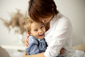 Mother and child, blond fashion preschool boy, having a wonderful family happy moment together