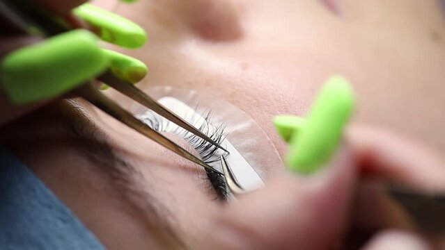 eyelash extension procedure the master performs the procedure with tweezers