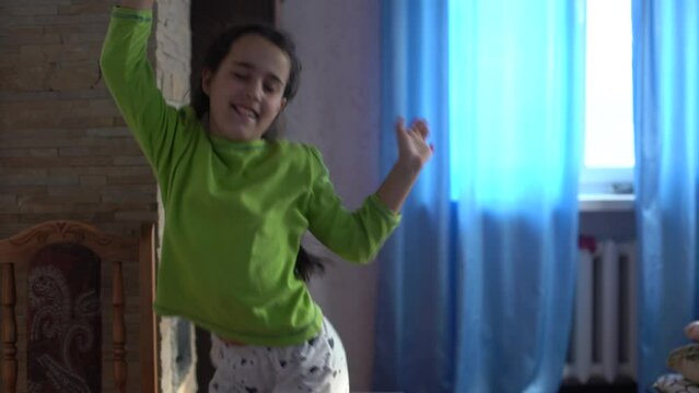 Teenager girl dancing, when making video for social media, stories hip hop popular trandy dance, students at home make content for video-focused social networking service