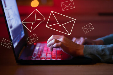 irl sends letters, emails using her laptop, hands on keyboard closeup.
