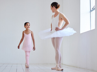 Are you ready for todays lesson. Shot of a little girl practicing ballet with her teacher in a...